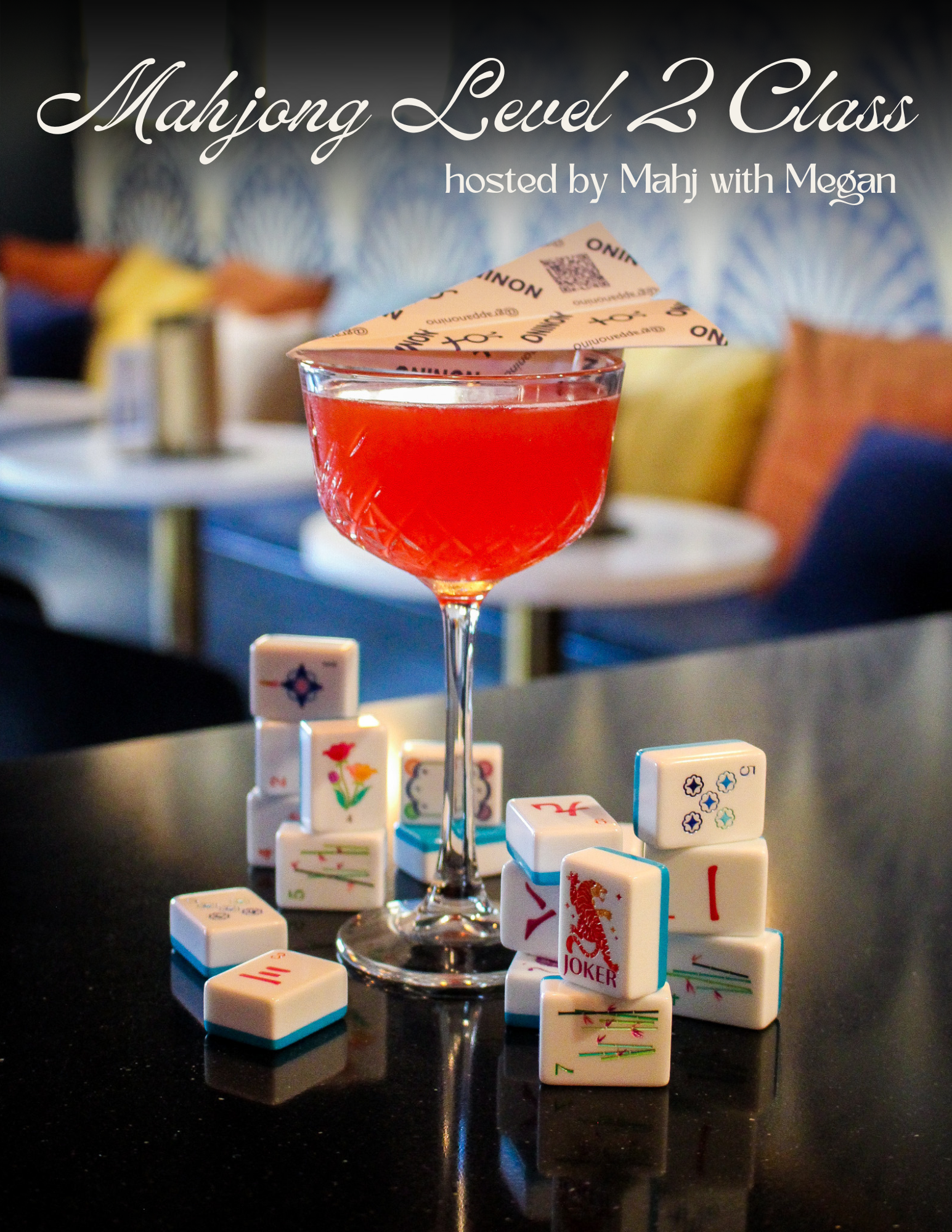 Red cocktail in a coupe glass with a paper umbrella, surrounded by stacked domino tiles on a glossy black tabletop.